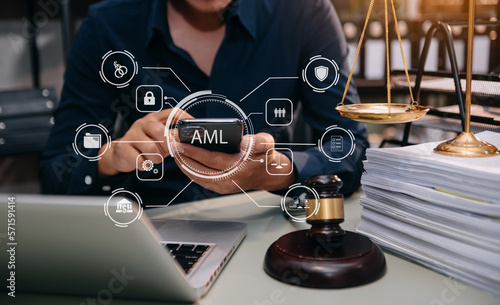 AML Anti Money Laundering Financial Bank Business Concept. judge in a courtroom using laptop and tablet with AML anti money laundering icon on virtual screen. .
