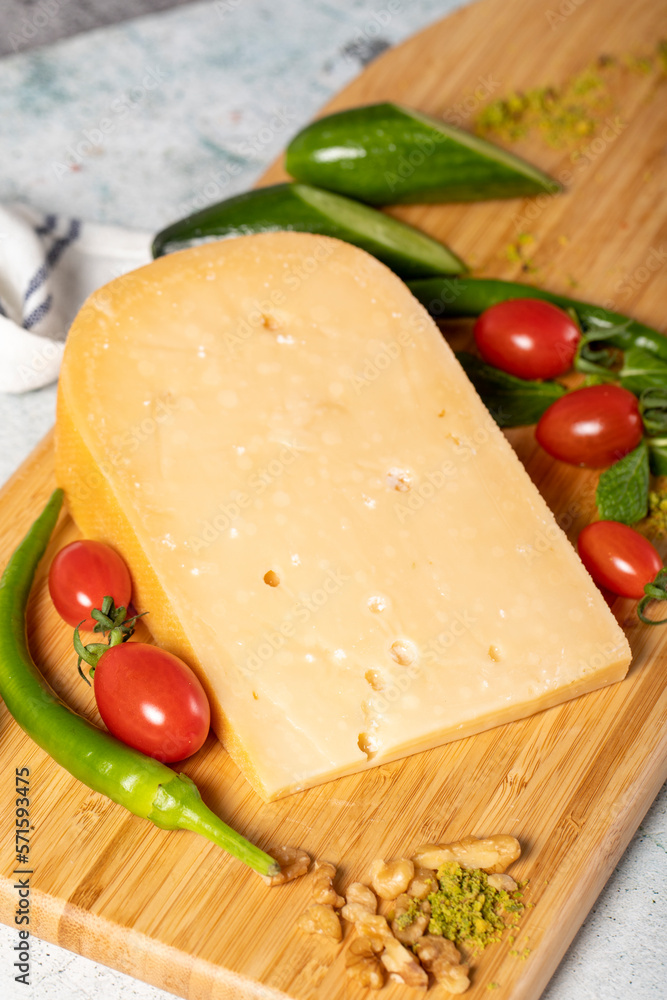Gouda cheese. Piece of gouda cheese on wooden cutting board. Cheese collection. Ripe hard cheese made from cow's milk in the Netherlands Gouda cheese. Piece of gouda cheese on wooden cutting board. Cheese collection. Ripe hard cheese made from cow's milk in the Netherlands
