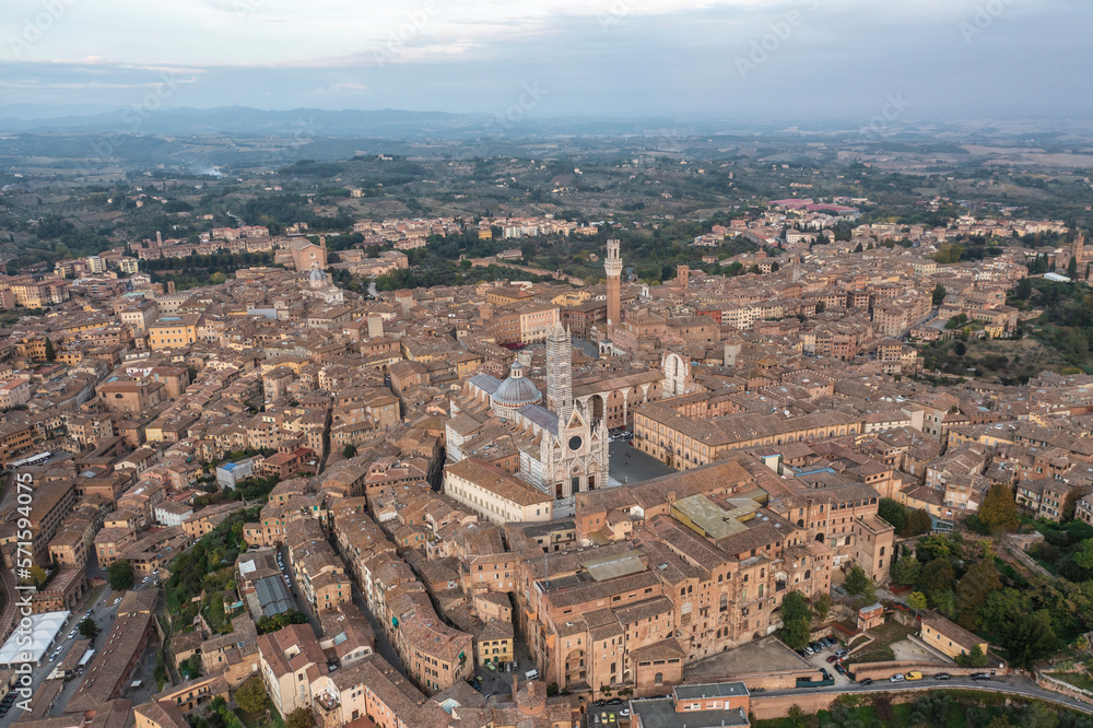 Panoramic aerial view of Siena cathedral in Siena downtown at sunset, Tuscany, Italy. Panoramic aerial view of Siena cathedral in Siena downtown at sunset, Tuscany, Italy.