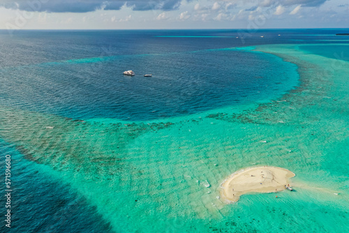 Aerial view of people on a small island with white sand, Thinadhoo, Vaavu Atoll, Maldives. photo