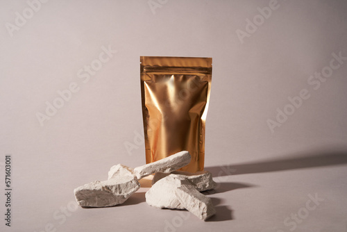 Bags made of gold kraft paper , front view with a shadow highlighted on a white light background. Layout of the packaging template for food and goods. Packaging with a clasp for tea leaves, coffee