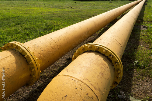 Gas delivery to remote regions. yellow gas pipeline that laid through green field. a long yellow pipe. photo