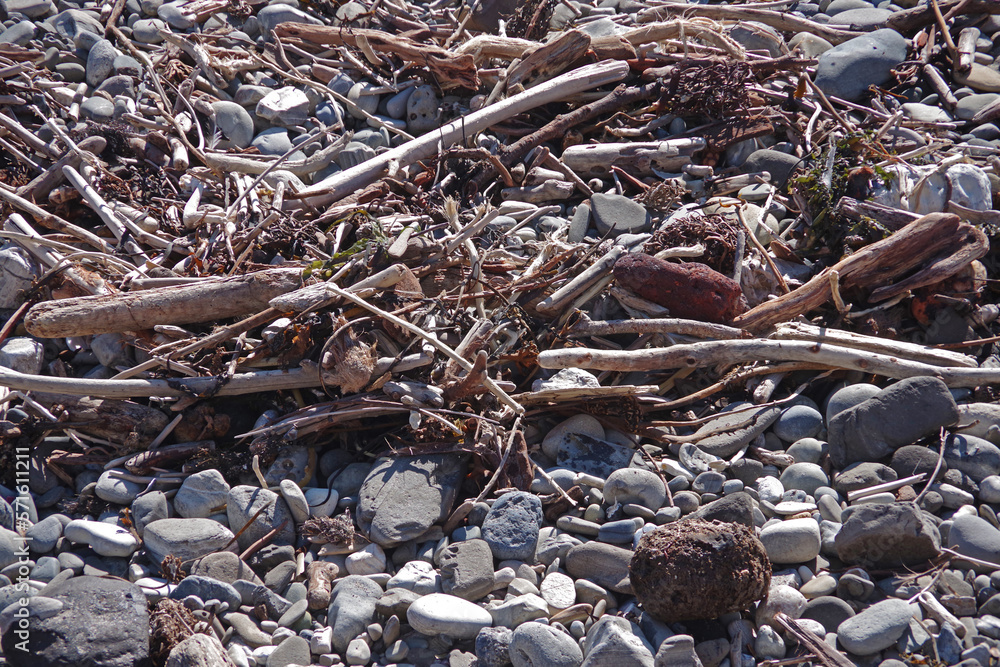 Rocks and debris on a pacific ocean beach after heavy winter storms