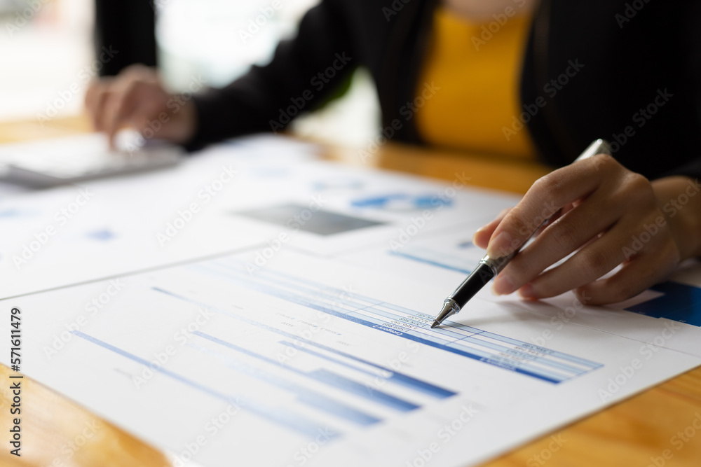 Businesswoman working with financial documents analyzing market growth report and company sales. Businesswoman working with financial documents analyzing market growth report and company sales.