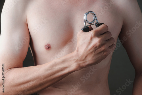 Close up Asian Man Taking off his shirt, Exercising hands with Hand Grip Strength, healthy skin, health care concept.