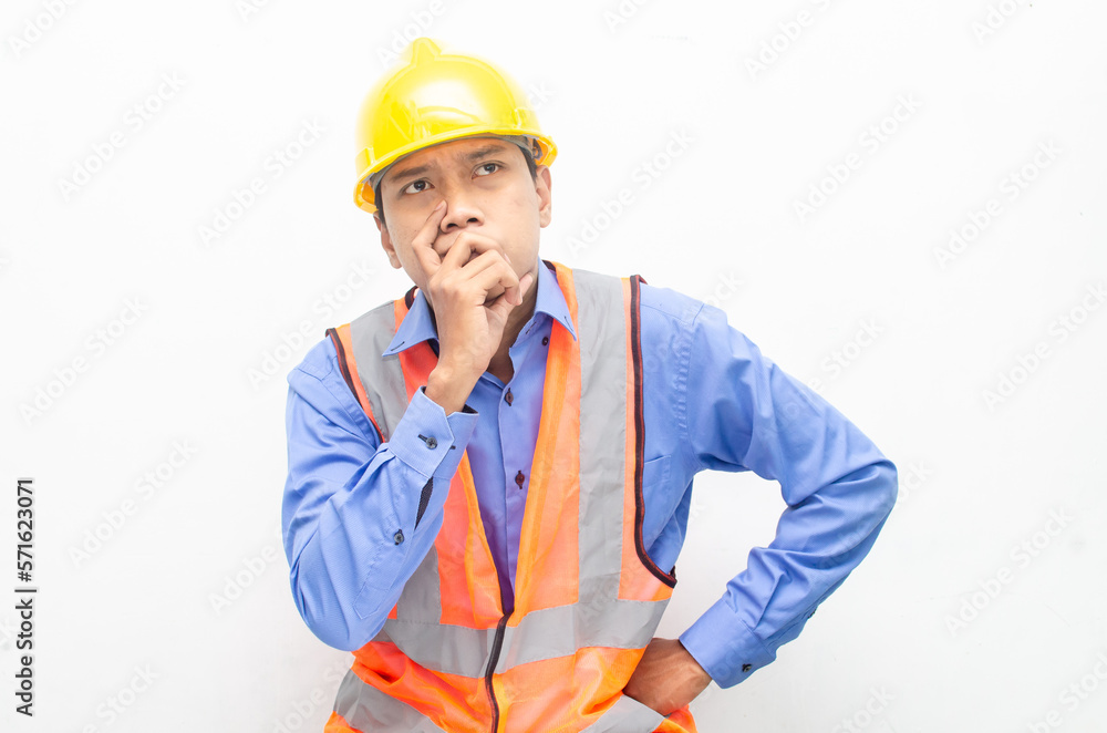 thoughtful asian male construction worker in pensive mood doing thinking and wondering gesture.