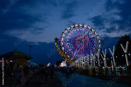 Joint wheel ride running under blue sky on fair ground for entertain the local and foreign tourists during the dussehra fair on ground. photo
