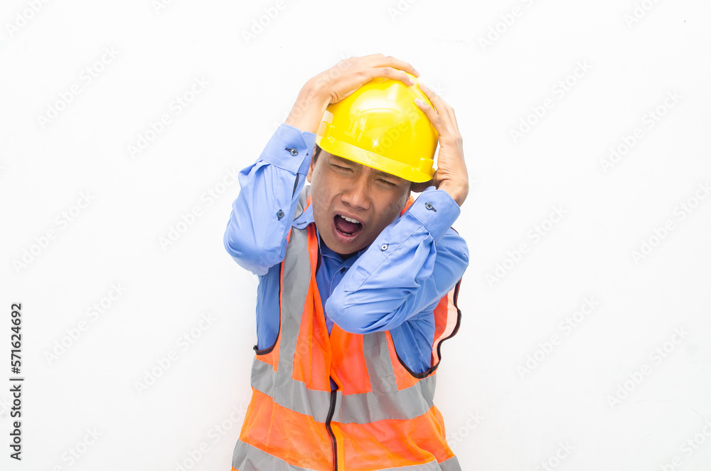 stressed over work concept illustrated by asian male construction worker in blue shirt, orange vest and yellow safety helmet with furious, mad, sad, angry expression. overworked concept stressed over work concept illustrated by asian male construction worker in blue shirt, orange vest and yellow safety helmet with furious, mad, sad, angry expression. overworked concept
