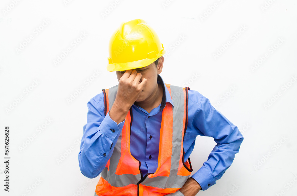 stressed over work concept illustrated by asian male construction worker in blue shirt, orange vest and yellow safety helmet with furious, mad, sad, angry expression. overworked concept stressed over work concept illustrated by asian male construction worker in blue shirt, orange vest and yellow safety helmet with furious, mad, sad, angry expression. overworked concept
