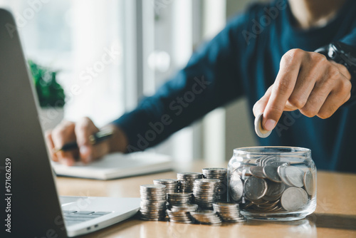Man hands putting coins stack, Concept business finance saving money and investment.