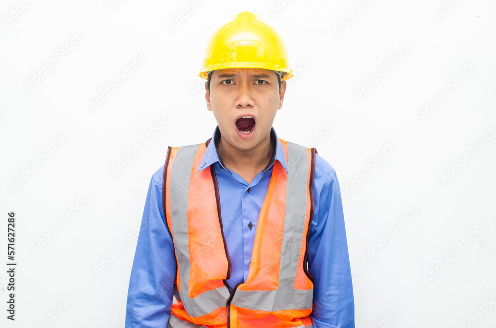 stressed over work concept illustrated by asian male construction worker in blue shirt, orange vest and yellow safety helmet with furious, mad, sad, angry expression. overworked concept stressed over work concept illustrated by asian male construction worker in blue shirt, orange vest and yellow safety helmet with furious, mad, sad, angry expression. overworked concept