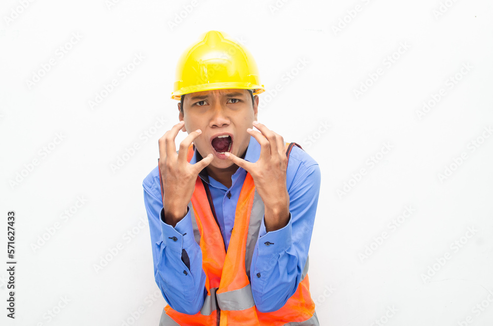 stressed over work concept illustrated by asian male construction worker in blue shirt, orange vest and yellow safety helmet with furious, mad, sad, angry expression. overworked concept stressed over work concept illustrated by asian male construction worker in blue shirt, orange vest and yellow safety helmet with furious, mad, sad, angry expression. overworked concept