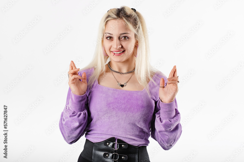 Happy woman wearing ribbed blouse standing isolated over white background looking at the camera with crossed fingers. Having high hopes enter university of dreams. Good luck. Happy woman wearing ribbed blouse standing isolated over white background looking at the camera with crossed fingers. Having high hopes enter university of dreams. Good luck.