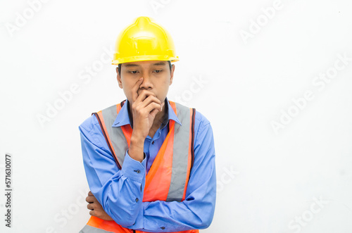 thoughtful asian male construction worker in pensive mood doing thinking and wondering gesture.