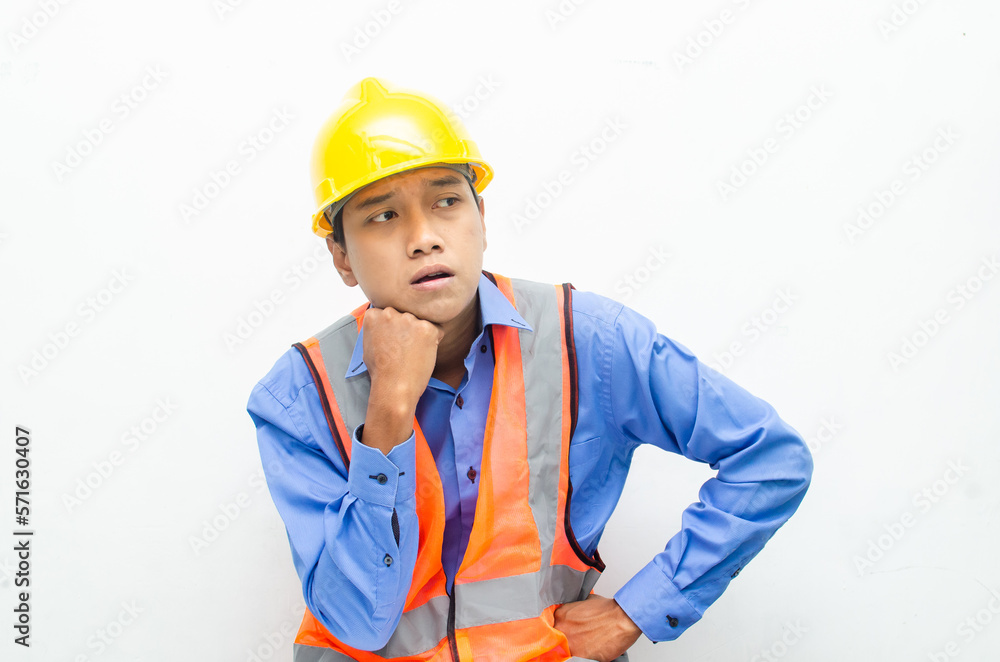 thoughtful asian male construction worker in pensive mood doing thinking and wondering gesture. thoughtful asian male construction worker in pensive mood doing thinking and wondering gesture.