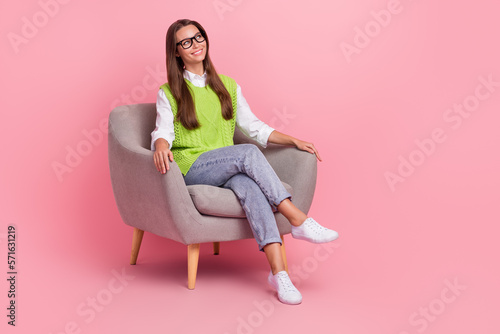 Full length photo of satisfied pleasant girl with straight hairdo dressed green vest look empty space isolated on pink color background
