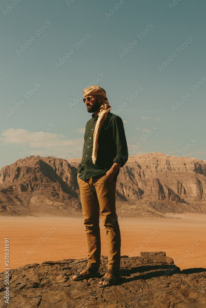 Naklejka premium A man with a beard in the desert wadi rum