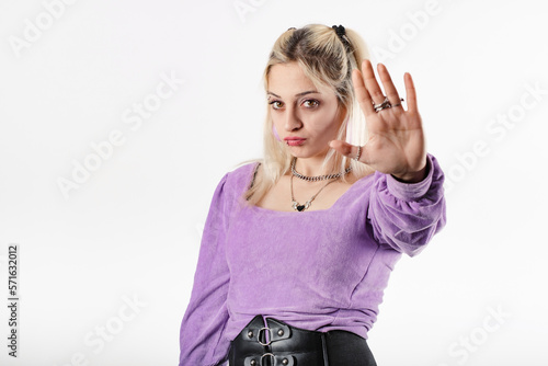 Young caucasian woman wearing blouse standing isolated over white background doing stop sing with palm of the hand. Warning expression with negative and serious gesture on the face.