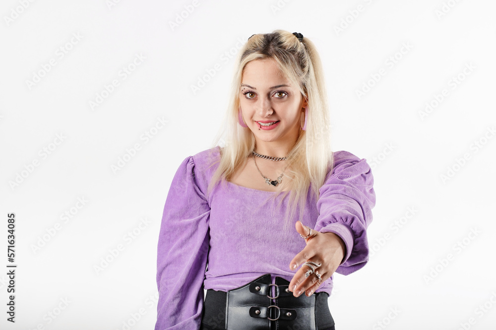 Portrait of cheerful woman wearing blouse standing isolated over white background offering palm hand giving assistance and acceptance. Concept of meeting, shaking hands. Smiles at the camera, at you. Portrait of cheerful woman wearing blouse standing isolated over white background offering palm hand giving assistance and acceptance. Concept of meeting, shaking hands. Smiles at the camera, at you.