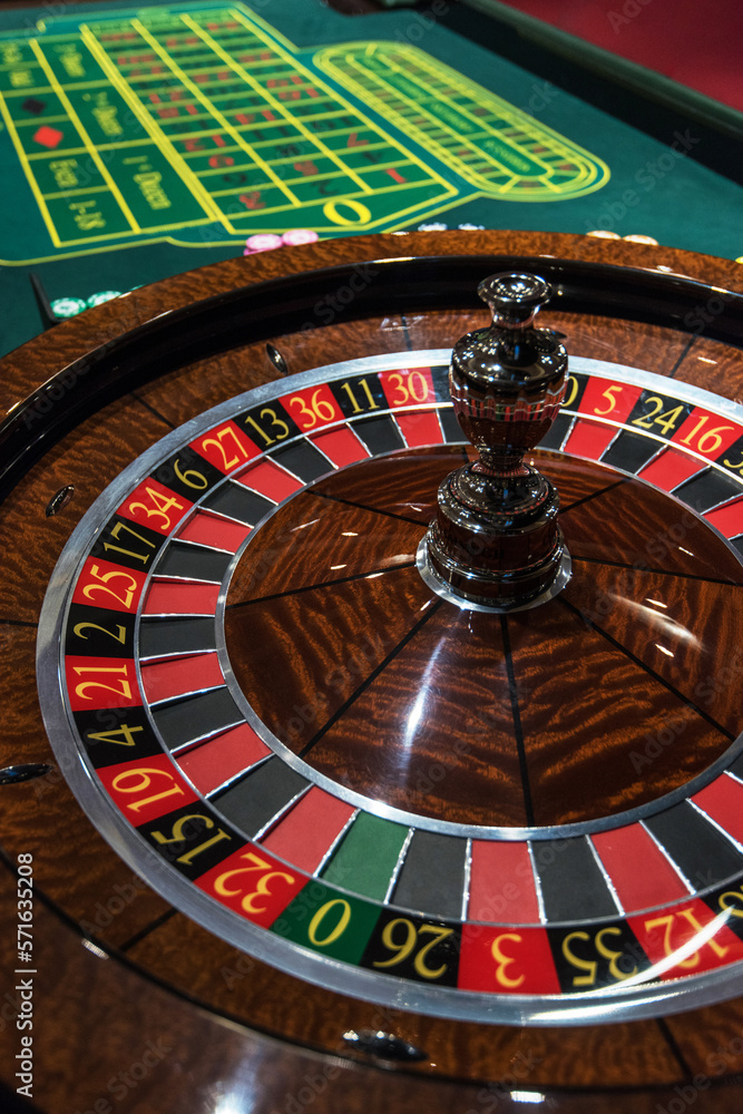 Roulette table and stack of poker chips - Casino, gambling concept Roulette table and stack of poker chips - Casino, gambling concept