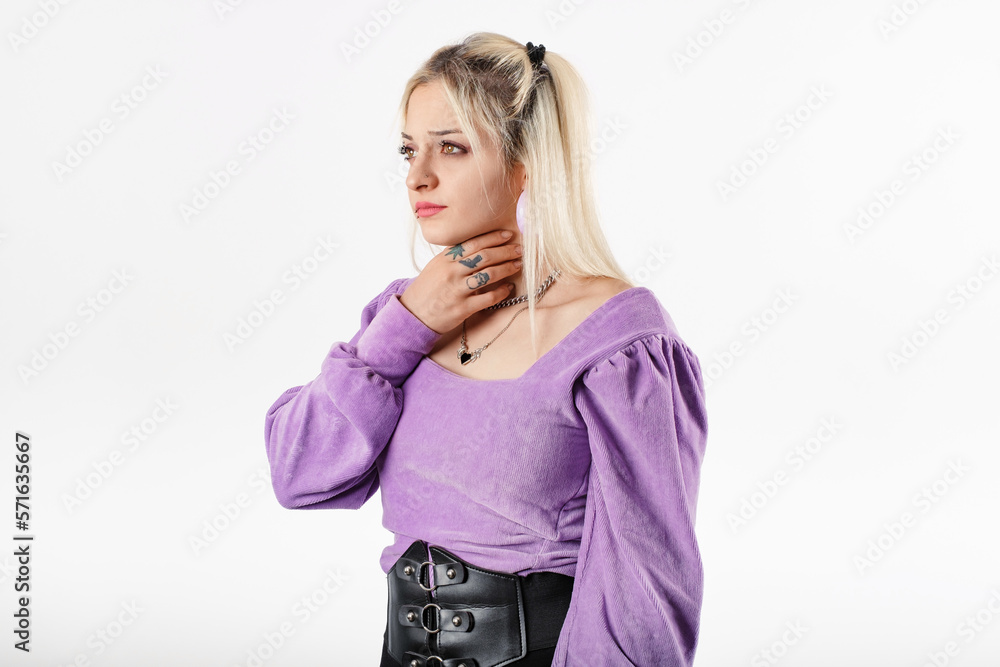 Woman standing isolated over white background holding her inflamed throat. Medical concept, Sore throat. Having sore throat, holding hand on her neck, suffering from throat pain, painful swallowing. Woman standing isolated over white background holding her inflamed throat. Medical concept, Sore throat. Having sore throat, holding hand on her neck, suffering from throat pain, painful swallowing.