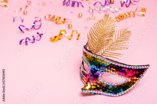 Festive mask for masquerade or carnival celebration on colored background