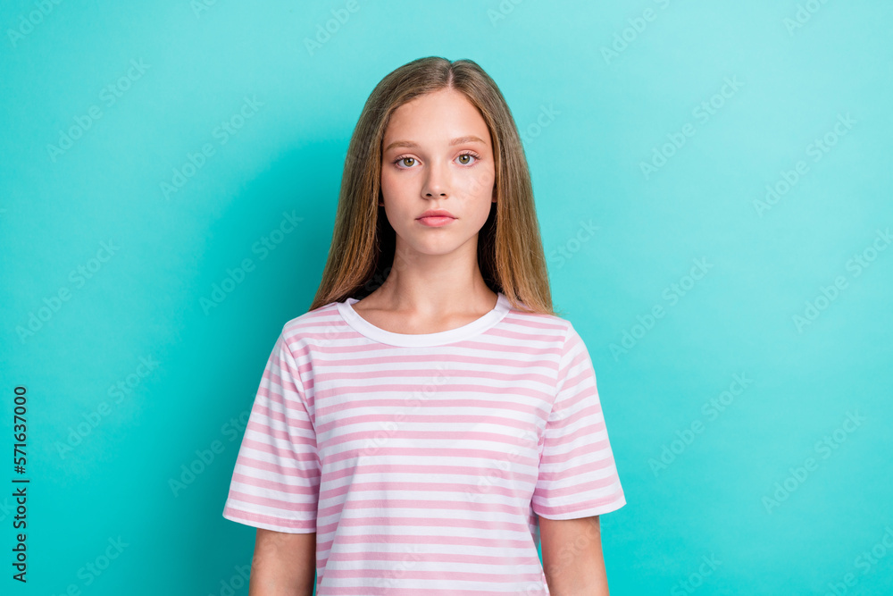 Photo of calm serious young girl look camera wear striped t-shirt isolated on aquamarine color background Photo of calm serious young girl look camera wear striped t-shirt isolated on aquamarine color background