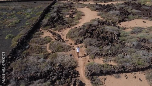 Drone pilot flying drone filming shooting video or taking photos on travel vacation in beautiful nature landscape on Lanzarote. High quality FullHD footage