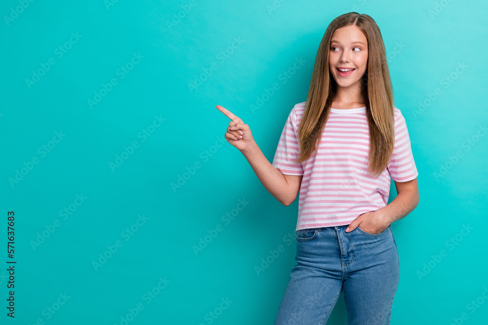 Photo of positive sweet person look indicate finger empty space blank isolated on teal color background Photo of positive sweet person look indicate finger empty space blank isolated on teal color background