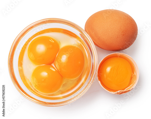 Brown chicken egg and egg yolks in glass bowl on white background. Clipping path.