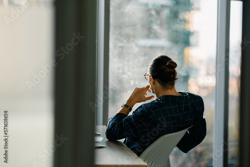 Rear view of businessman looking through window of his office. Free Download Rear view of businessman looking through window of his office. - GFXLoad