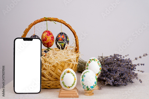 lavender background postcard baner calendar empty space holiday easter eggs embroidery ribbons on eggshell krashanka against the background of a shopping cart phone white screen Easter eggs Lavender photo