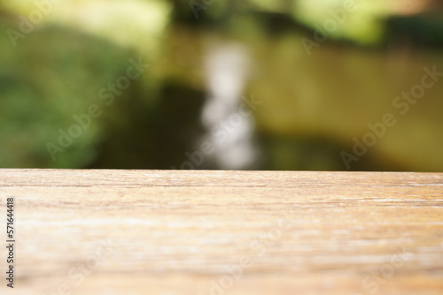 Empty wood table top and blur glass window wall building banner mock up abstract background - can used for display or montage your products. Selective focus