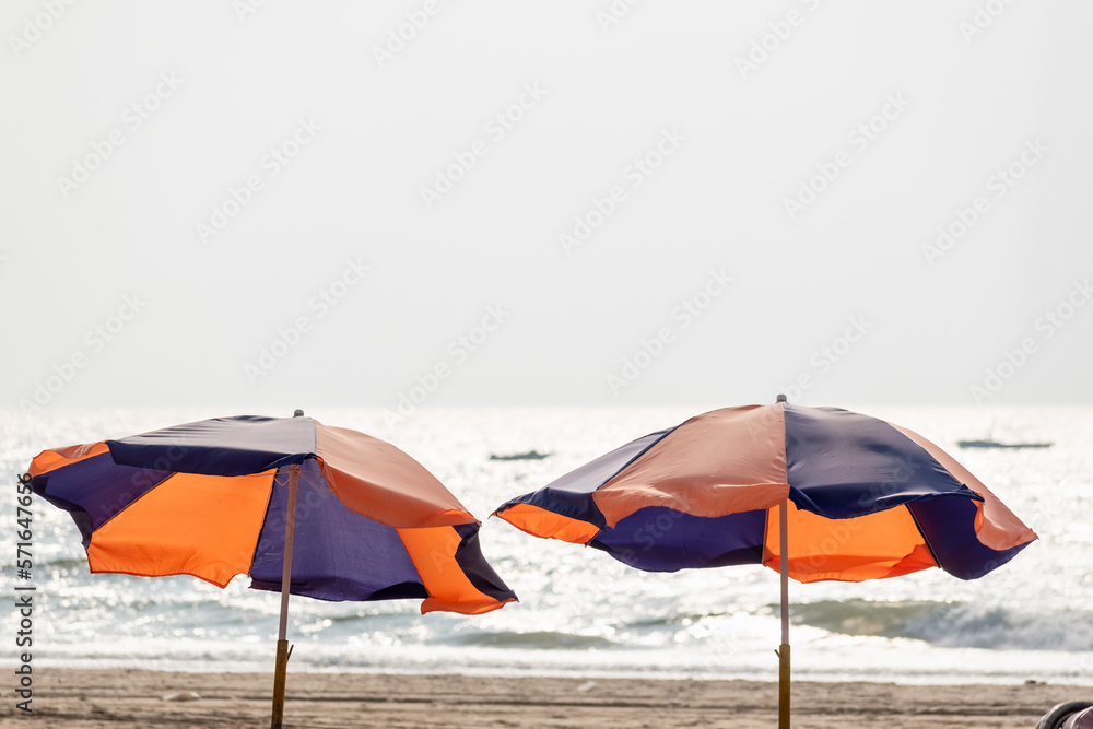 Colorful umbrellas of a beach shack with a view of the sea at the beach in Calangute in Goa.