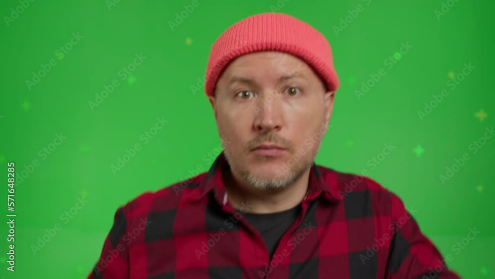 Extreme close-up of a caucasian man in red shirt and beanie having fun dancing on a Green Screen, Chroma Key. Extreme close-up of a caucasian man in red shirt and beanie having fun dancing on a Green Screen, Chroma Key.