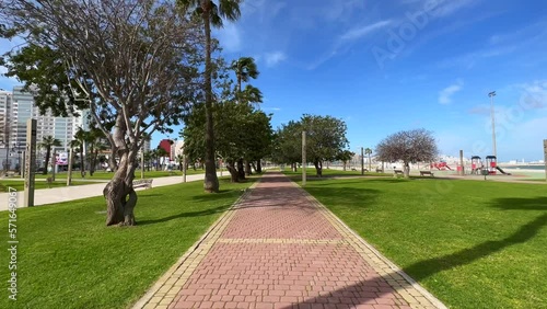 POV walking on the walkway in a public garden in Tangier, Morocco