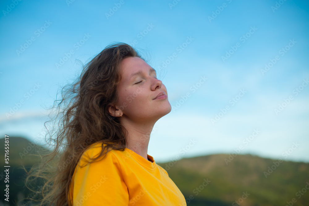 Portrait of happy pensive thoughtful relaxed young woman standing outdoors at natural sky and mountain background at summer sunny day dreaming, thinking Portrait of happy pensive thoughtful relaxed young woman standing outdoors at natural sky and mountain background at summer sunny day dreaming, thinking