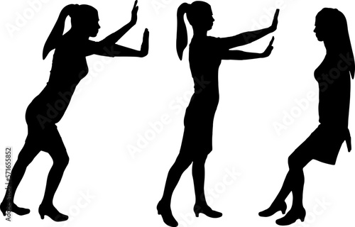 A businesswoman or woman worker pushes an object and exerts physical effort. Effort business concept.