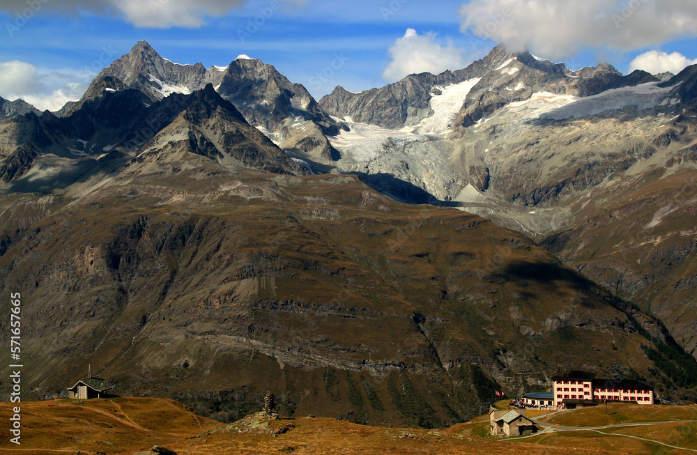 Landscape with mountain ranges with snow on the tops and mountain huts on a Mount Gornergrat, near Zermatt, in southern Switzerland Landscape with mountain ranges with snow on the tops and mountain huts on a Mount Gornergrat, near Zermatt, in southern Switzerland