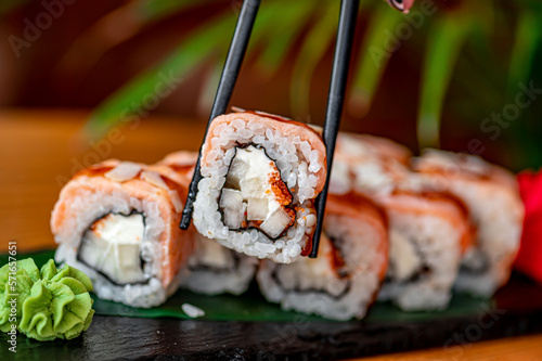 Sushi rolls with grilled salmon and pear.