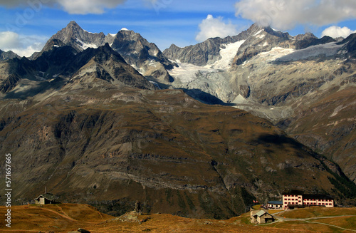 Landscape with mountain ranges with snow on the tops and mountain huts on a Mount Gornergrat, near Zermatt, in southern Switzerland