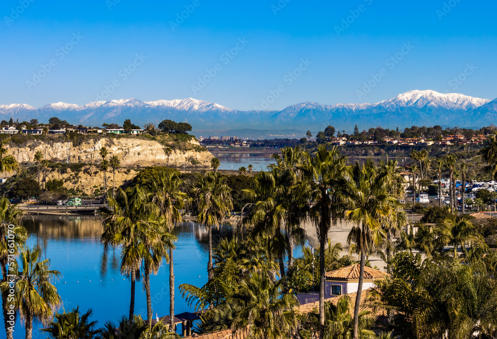 view of Newport Beach upper back bay and snow capped San Gabriel mountains on a sunny winter day