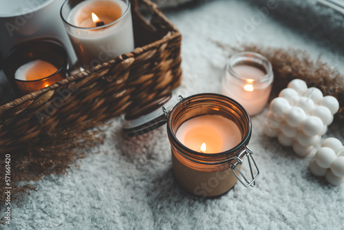 Burning candle in cozy home interior