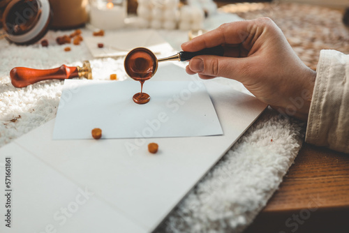Φωτογραφία Girl making greeting card and sealing the envelope with wax sealing stamp