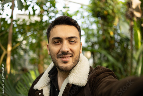 Young tourist man taking selfie in forest.