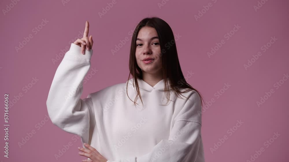 4k video of one girl thinking about something and showing thumb up on pink background. 4k video of one girl thinking about something and showing thumb up on pink background.