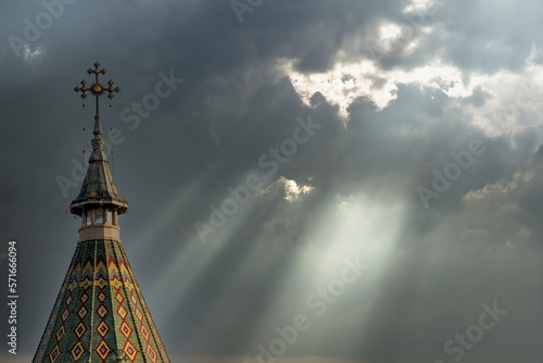 Church cross and storm clouds with light rays. Apocalypse background. Halloween concept. Hope concept.