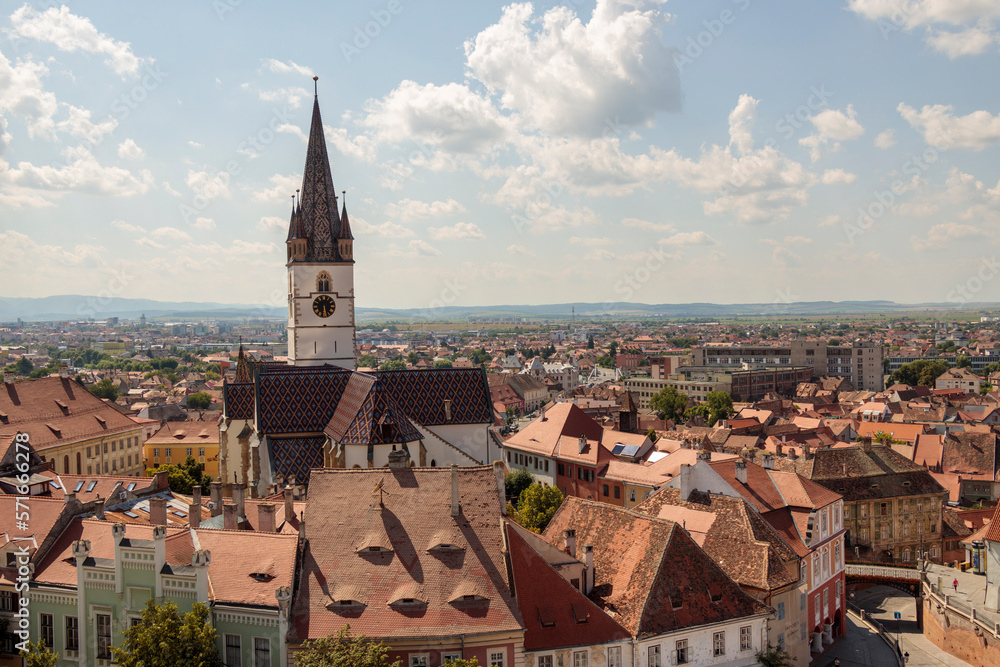 Aerial drone view of the Historic Center of Sibiu, Romania. Lutheran Cathedral, old buildings, narrow streets and the main big city Square
