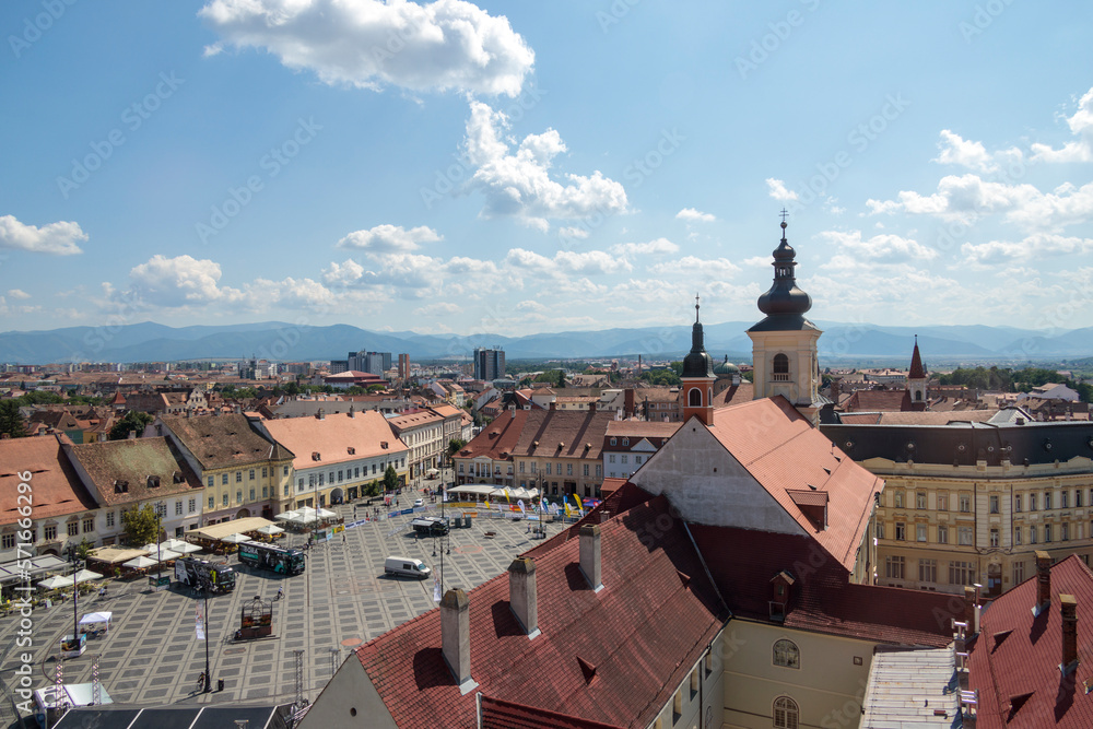 Aerial drone view of the Historic Center of Sibiu, Romania. Lutheran Cathedral, old buildings, narrow streets and the main big city Square