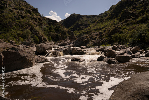 Panorama view of Yuspe river in the rock massif Los Gigantes in Cordoba, Argentina. View of the water flowing across the rocky hills. 